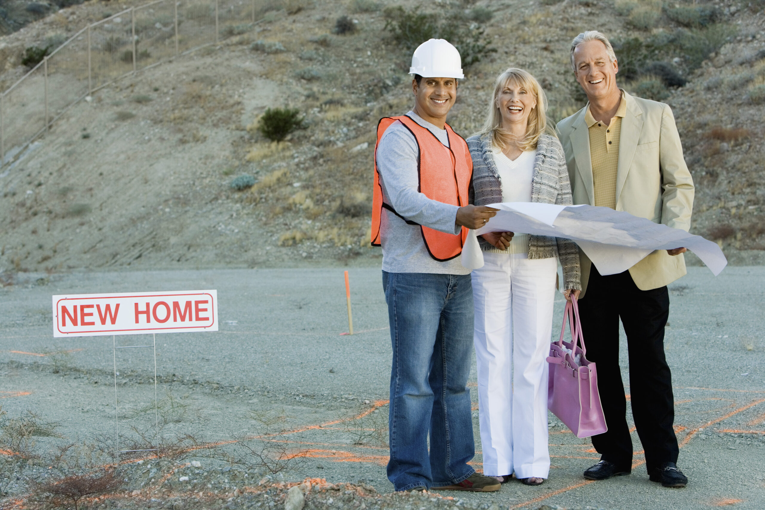Couple with builder at homesite
